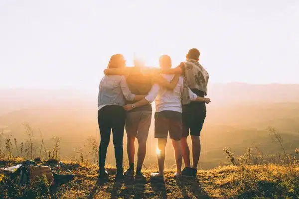 Friends hiking to the top and enjoying sunrise