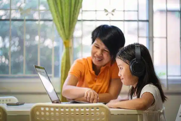 Mom and daughter on laptop during a Telemental health session