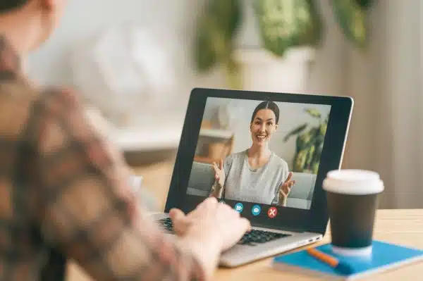 Man is using laptop for video chat with Equity Associates