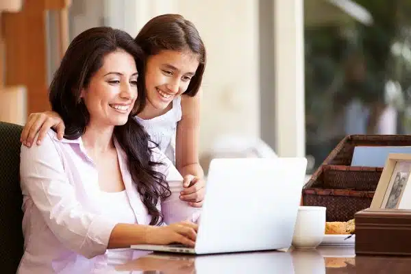 mother and daughter checking email