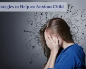 Anxious child holding their head in their hands with scribbles around their head.