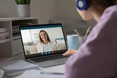 Teenager and counselor during a session on laptop