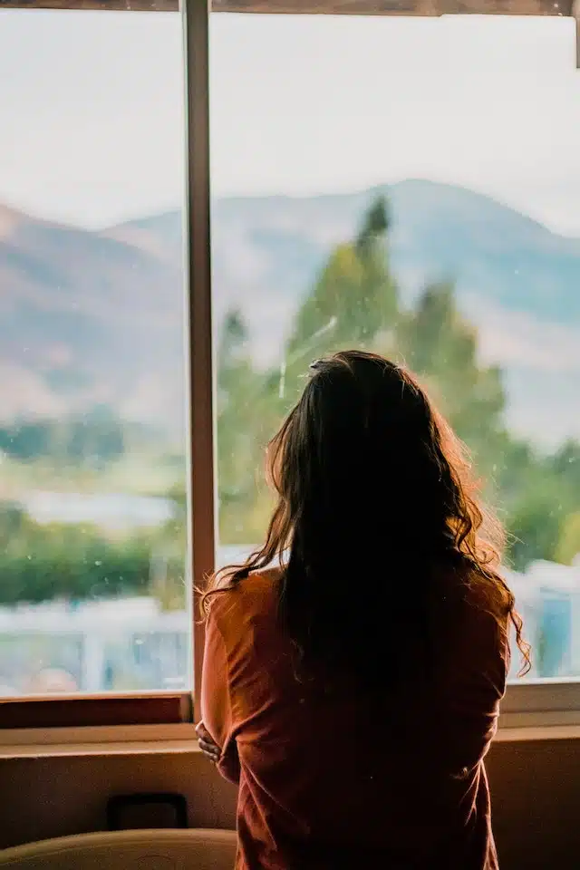 woman staring out a window